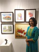 Sanika Dhanorkar with her paintings at the second edition of Emerging Artists Show at Indiaart Gallery, Pune